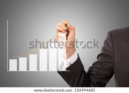 Male hand drawing a graph, grey background