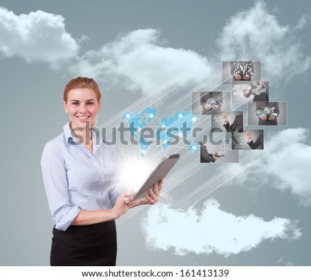 Portrait of businesswoman holding her tablet computer and communicating with her team across the world.