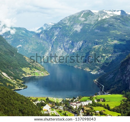 Norway cruise: mountains and village in Geiranger fjord.