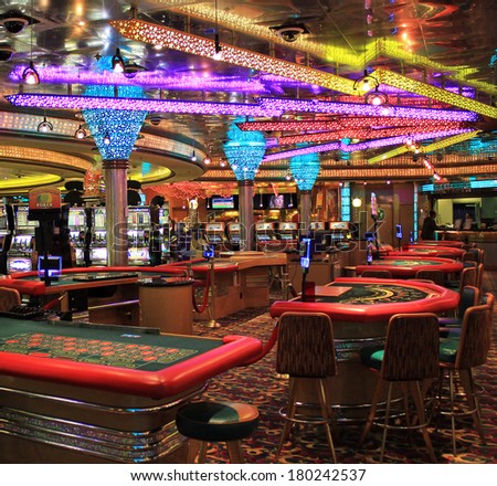 Poker table and gaming slot machines in American gambling casino.