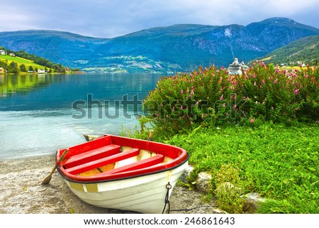 Boat on the beach of Norwegian village Olden in Norwegian fjords.