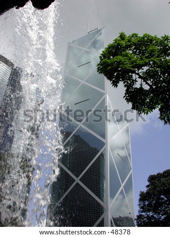 Bank of China building in Hong Kong taken from behind a waterfall in a nearby park.