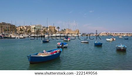 BARI, ITALY, JUNE 16, 2014: Fishermen boats are anchoring inside port of Bari in Italy.
