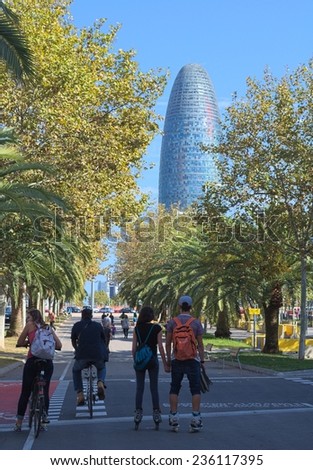 BARCELONA, SPAIN, OCTOBER 24, 2014: People are waiting for the green light in front of the torre agbar in barcelona.