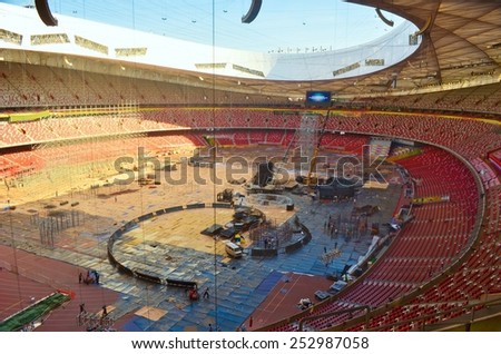 BEIJING, CHINA, AUGUST 20, 2013: workers are constructing new stage inside of the birds nest olympic stadium in chinese beijing.