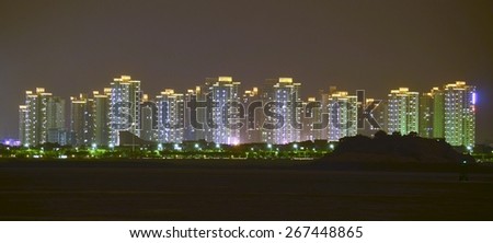 XIAMEN, CHINA, OCTOBER 22, 2013: view of illuminated seaside of xiamen city in china during night.