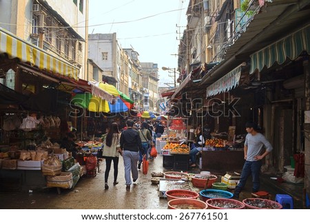 XIAMEN, CHINA, DECEMBER 7, 2013: People are buying various articles in overcrowded central market in chinese city xiamen.