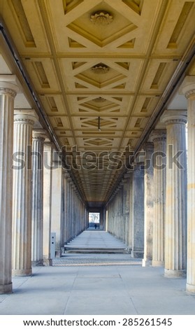 arcade of antique columns decorated by symmetric ceiling next to the pergamonmuseum in berlin.