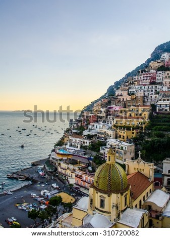 view of italian city positano situated on amalfi coast during summer sunset