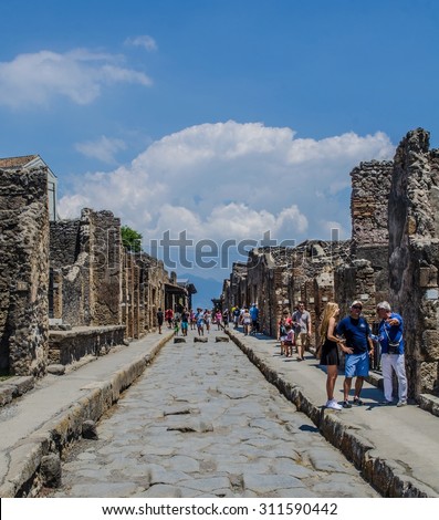 POMPEII, ITALY, JUNE 27, 2014: people are walking through the ruins of former italian city pompeii near naples.