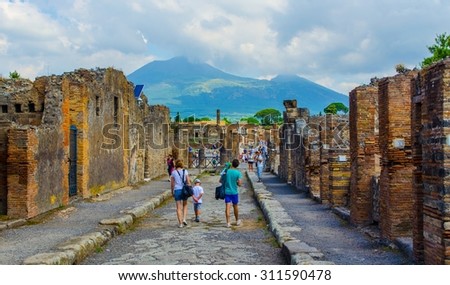 POMPEII, ITALY, JUNE 27, 2014: people are walking through ruins of the historical city of pompeii.