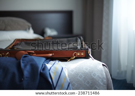 Jacket and bag on the bed in hotel room