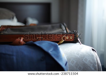 Jacket and bag on the bed in hotel room