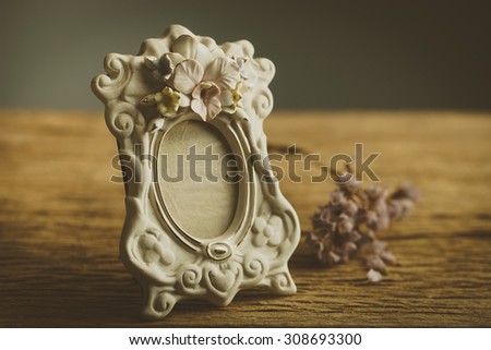 Still life with vintage classic photo frame and dry flower