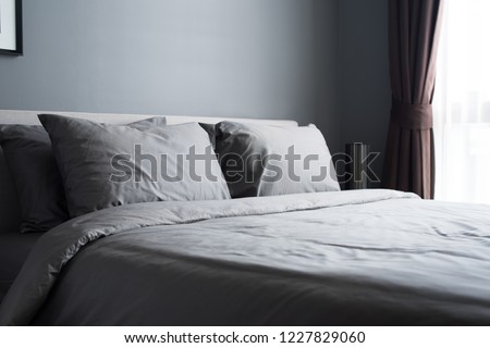 Similar – Foto Bild Das Bett ist mit sauberen weißen Kissen und Bettwäsche im Zimmer ausgestattet.