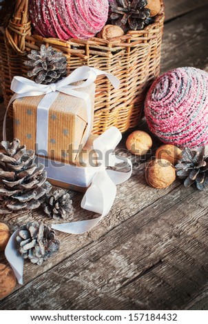 Christmas Composition with box, basket, pine cones and walnuts, close up