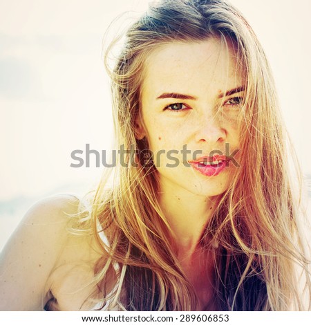 Portrait of Beautiful Blonde Woman with Fair Hair. Outdoor Before Blue Sea in Sunrise. Summer day. Toned