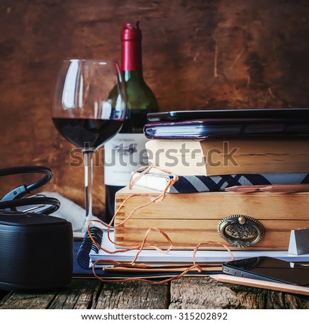 Memories in Men\'s Things with Different Accessories on Warm Wooden Table. Books, daily logs, wine, box and earphones