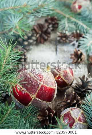 Christmas Composition with Red Balls, Pine Cones, Fir Tree on Wooden Background. Country style