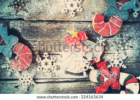 Festive Vintage Wooden Fir Tree Toys Candy Canes, Bell on Wooden Desk. Decorated with Snowflakes. Toned