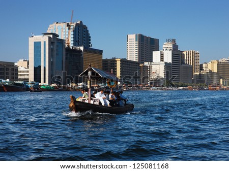DUBAI CREEK, UAE - MAY 27 - Skyline view of Dubai Creek with traditional boat taxi activity. The creek is dividing the city into two main sections  Deira and Bur Dubai. Picture taken on May 27, 2010.