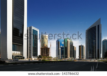 DOHA, QATAR - MAY 2: Tall buildings of the West Bay on May 2, 2013 in Doha, Qatar. The West Bay is rapidly expanding urban center of Doha with numerous skyscrapers gracing the skyline of the city