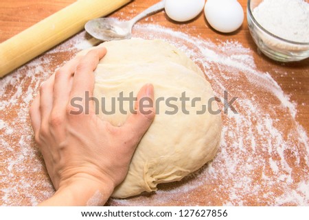 Woman\'s hand working the dough. Process of bread cooking close up.