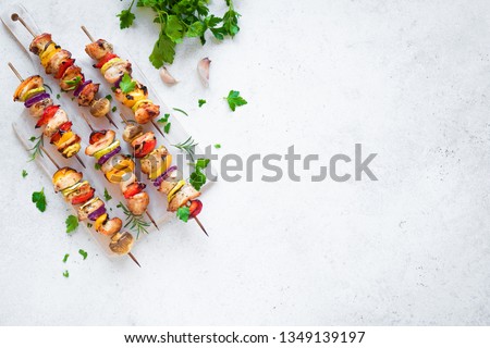 Grilled Chicken and Vegetable Skewers with  bell peppers, zucchini, onion and mushrooms on white background, top view, copy space. Meat and vegetables kebabs on skewers. ストックフォト © 