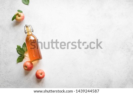 Similar – Image, Stock Photo Homemade apple vinegar in bottle with apples and green leaves on white background. Top view