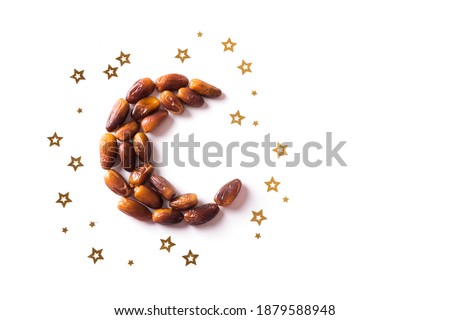 Islamic Crescent. Ramadan kareem with dates fruits arranged in shape of crescent moon isolated on white background, top view, copy space. Iftar food concept.