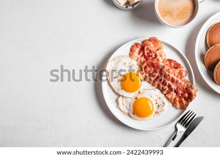 Similar – Image, Stock Photo Tasty bacon and eggs with juice at table