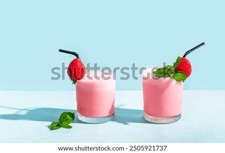 Similar – Image, Stock Photo Strawberry smoothie. Two glasses of berry slush. Summer cold drink