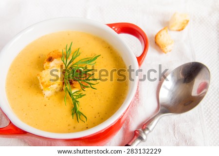Lentil cream soup with croutons and dill, horizontal close up