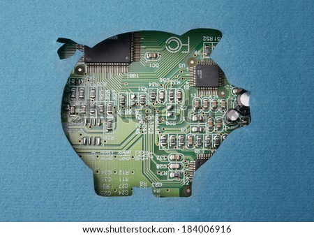 Money and technology. Cardboard piggy bank cutout revealing circuit board content