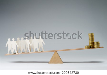 Men balanced on seesaw over a stack of coins