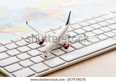 Model airplane on computer keyboard
