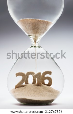 New Year 2016 concept with hourglass falling sand taking the shape of a 2016