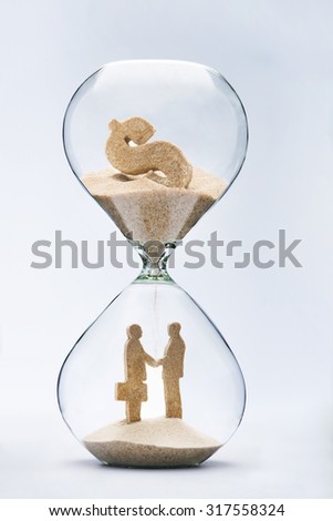 Business deal. Two businessmen shaking hands made out of falling sand from dollar sign flowing through hourglass