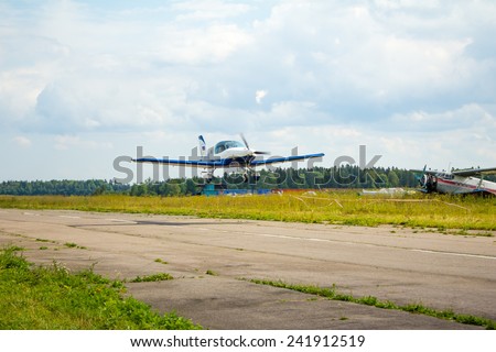 St. Petersburg, Russia - CIRCA August 2014: The plane flies over the runway. He had just lifted off and climbs. This is a small private plane.