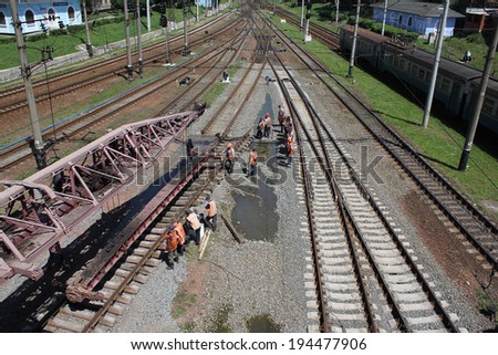 KIEV, UKRAINE - MAY 22, 2014: Renovation of the railway. Workers change the old site to the new railway