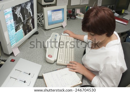 Khmelnik, UKRAINE - 20 May 2011: Experienced doctor with an MRI scan of the cervical portion on Monitor