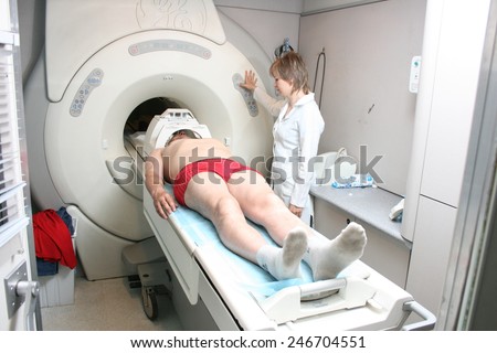 Khmelnik, UKRAINE - 20 May 2011: Medical technical assistant counselling patient and preparing scan of magnetic resonance tomography MRI in radiology