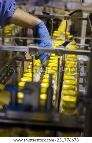 Kiev region, UKRAINE - 15 November 2014: Dairy baby food factory. Worker conducts quality control at conveyor belts