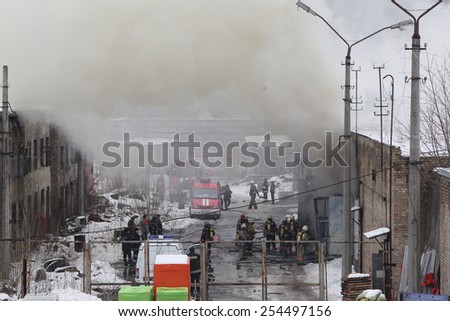 Kiev, UKRAINE - 20 February 2015: Firefighters extinguish a warehouse. The building is in smoke