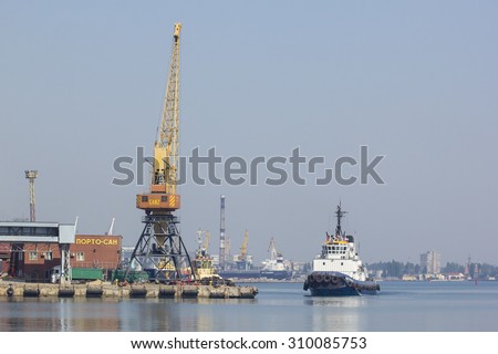 Odessa, Ukraine - July 26, 2015: Cargo cranes on rails and cargo warehouses in the seaport. Port of Odessa is the largest Ukrainian seaport with annual traffic capacity of 40 million tonnes