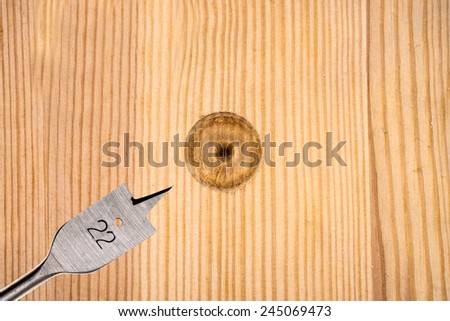 Hole in wood drilled with flat bit