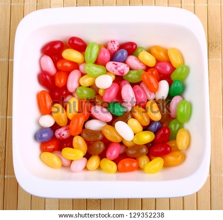 Colorful jelly beans in white bowl. Shot from above.
