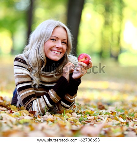 eat apple in autumn park