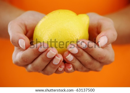 lemon in woman hands