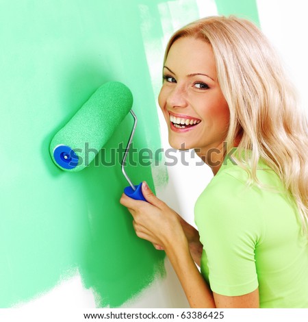 woman paints the wall